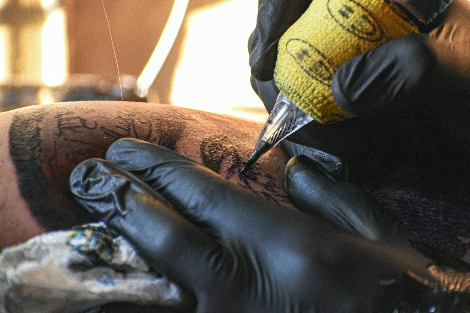 A man getting a tattoo on his leg